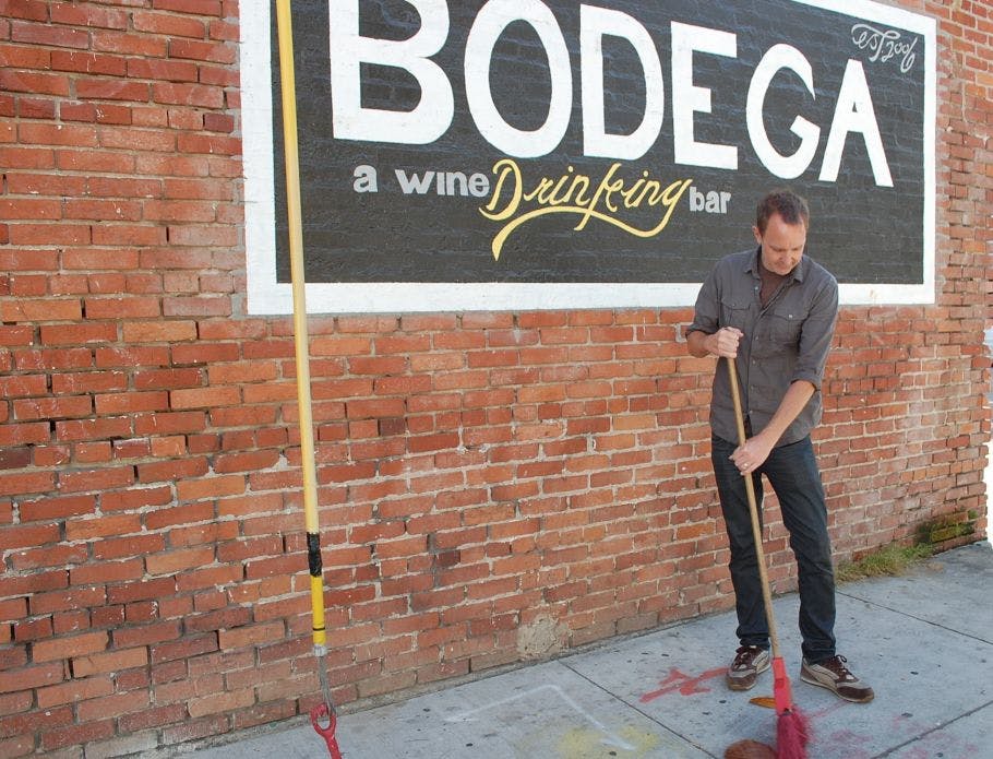 Clean Bay Certified Bodega Wine Bar staff dry sweeping, not hosing.